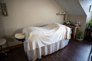 Comfortable spa acupuncture table in treatment room